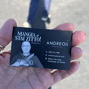 a man holding a business card