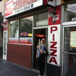 a woman standing in front of a restaurant