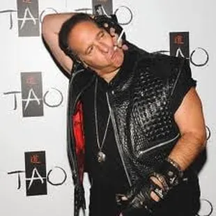 a man in a leather jacket and gloves