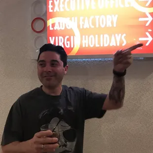 a man pointing at a sign
