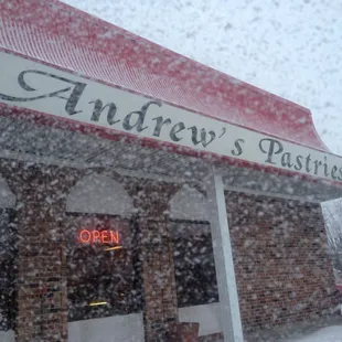 snow falling in front of a store