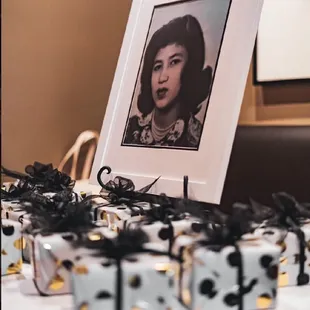 a portrait of a woman surrounded by gift boxes