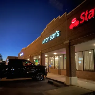a pickup truck parked in front of a restaurant