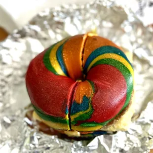 Rainbow egg, sausage, and cheese bagel