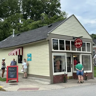 people standing outside of the store