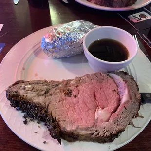 a plate of roast and a bowl of sauce