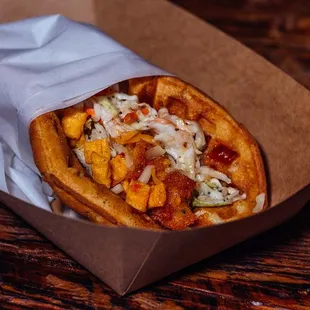 a hot dog in a paper wrapper