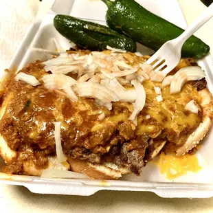 A &quot;Chili-size&quot;, big open-face burger smothered in chili &amp; cheese. Added hot sauce, onion &amp; jalapeños by request. So delicious.