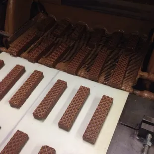 Peanut butter nutty bars headed into the chocolate shower