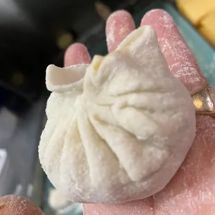 a hand holding a doughnut