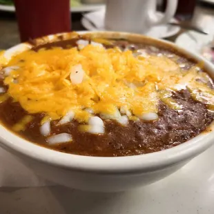 a bowl of chili and cheese