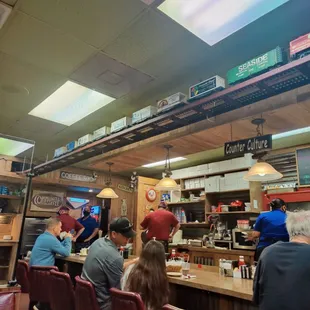 Two trains circle the restaurant. The counter area displays the most delicious looking pies.