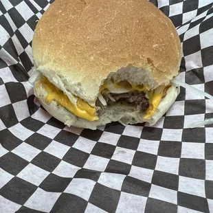 a hamburger with cheese and mustard