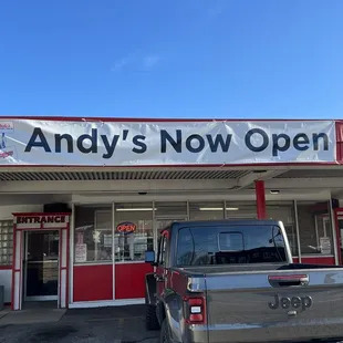 a pickup truck parked in front of the store