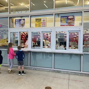 two children looking at the window