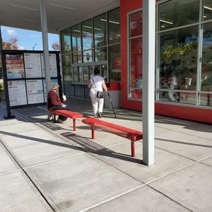 a man and a child sitting on a bench