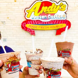 two people holding cups of ice cream