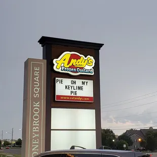 a car parked in front of the sign
