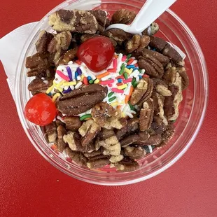 Hot fudge sundae with pecans and sprinkles