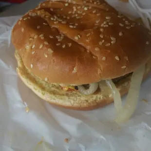 a hamburger with onions and cheese