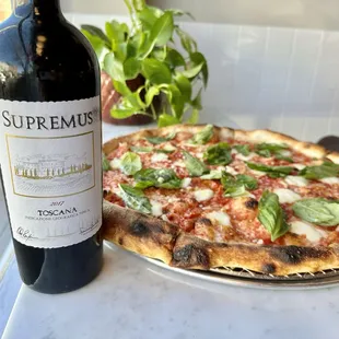 a bottle of wine and a pizza