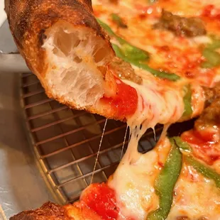 a slice being taken out of a pizza