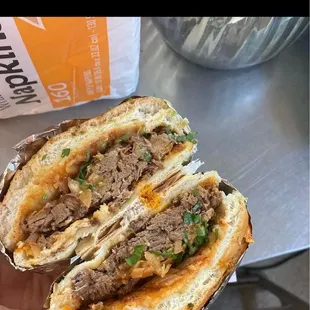 a hand holding a sandwich