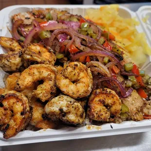 grilled shrimp and vegetables in a styrofoam container