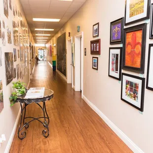a long hallway with pictures on the wall