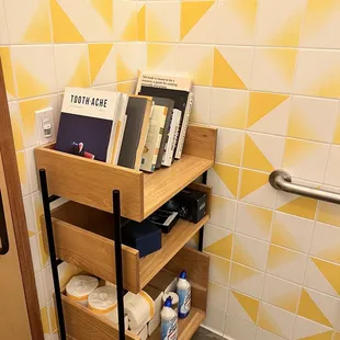 Cute bathroom with a bookshelf haha.