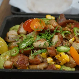 Pork Belly Chicharron, hass avocado puree, baby heirloom tomatoes, corn, serrano chiles, cilantro and organic tortillas.