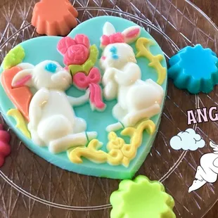 a heart shaped cake decorated with fondant animals