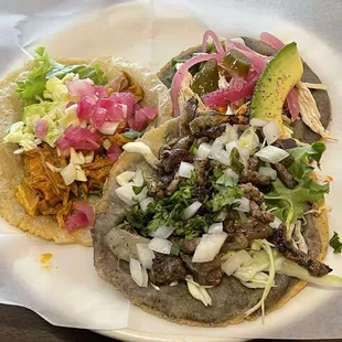 two tacos on a paper plate