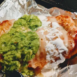 Angela&apos;s Burrito Suizo - choice of meat, lettuce, tomato, cheese, sour cream, pinto beans, ranchera sauce, melted cheese &amp; guac.