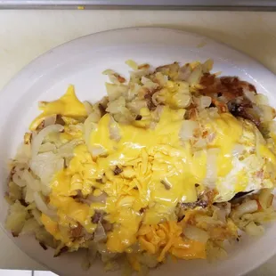 Everything omelette with home fries on top with onions and American cheese melted