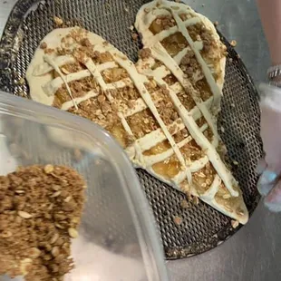 a heart - shaped pie being prepared
