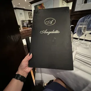 a person holding a menu