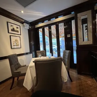 a dining room with a table and chairs