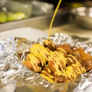a hot dog with mustard drizzle