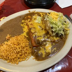 Monday&apos;s Special 2 enchiladas 1 puffy taco W/ rice and beans and a Tea