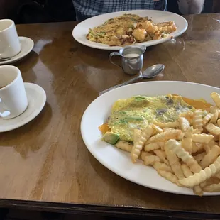 a plate of french fries and omelet