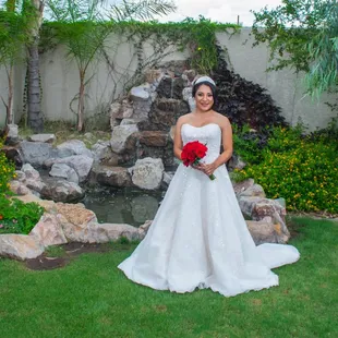 Bride in front of turtle pond/waterfall