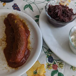 Curry wurst with a side of red cabbage and cucumber salad