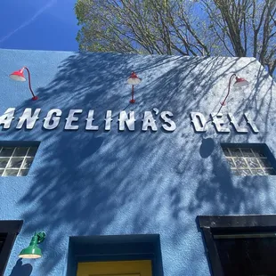 a blue building with a sign that says angelina's deli