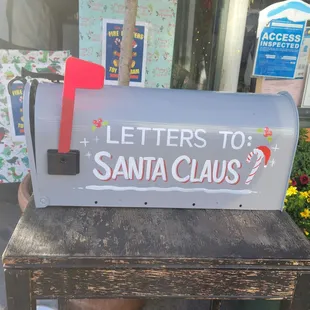 Cutesy mailbox outside of shop.