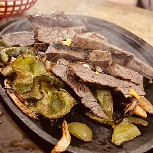 a plate of steak and vegetables