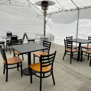 tables and chairs under a tent