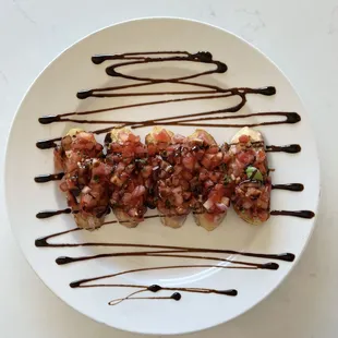 Bruschetta | House made crostini topped with fresh tomato, basil, olive oil, red onion &amp; balsamic reduction.