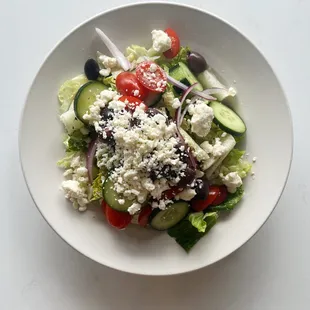 Greek Salad* | Romaine, roma tomato, Kalamata olive, cucumber, red onion, pepperoncini &amp; feta cheese.