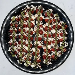Catering Menu | Caprese Salad | Sweet grape tomatoes, fresh mozzarella, basil pesto and balsamic reduction.